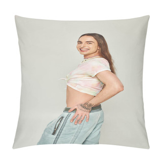 Personality  Cheerful Young Gay Man With Tattoo And Long Hair Standing In Denim Jeans And Tied Knot On T-shirt Showing His Belly And Looking At Camera On Grey Background, Pride Month Concept  Pillow Covers
