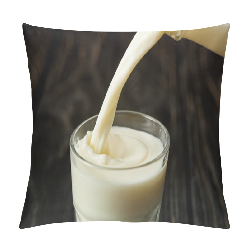 Personality  milk pouring into glass from bottle on black wooden surface  pillow covers