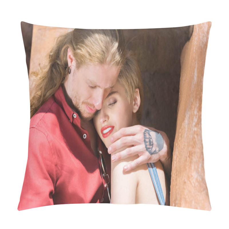 Personality  boyfriend with tattoos and stylish girlfriend sitting and hugging on street pillow covers