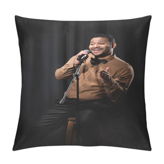 Personality  Happy Indian Comedian Sitting On Chair And Performing Stand Up Comedy Into Microphone On Black  Pillow Covers