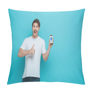 Personality  KYIV, UKRAINE - APRIL 23, 2019: Excited Young Man Showing Thumb Up While Holding Smartphone With Zoom App On Screen On Blue Background Pillow Covers