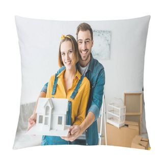 Personality  Smiling Couple Holding Toy House And Looking At Camera At Home Pillow Covers