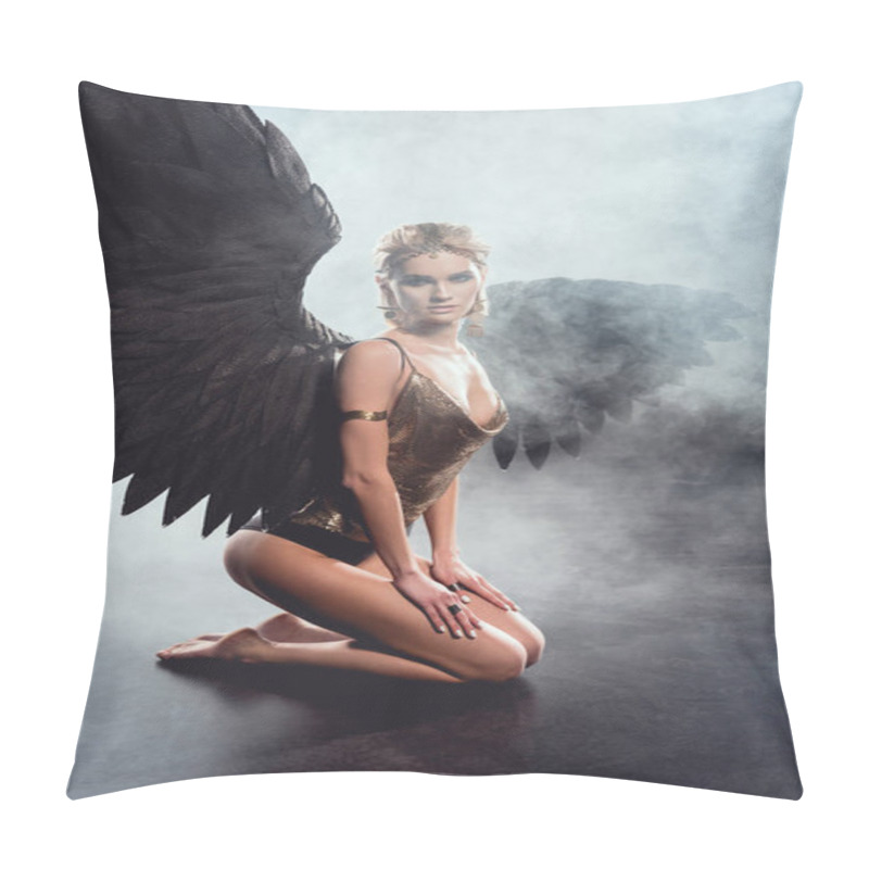 Personality  beautiful sexy woman with black angel wings sitting, looking at camera and posing on dark background pillow covers