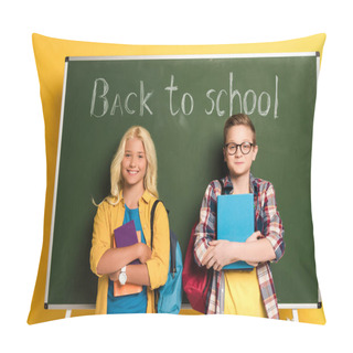 Personality Smiling Schoolkids Holding Books And Standing Near Chalkboard With Back To School Lettering  Pillow Covers