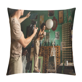 Personality  Blurred Man With Vintage Camera Pointing With Hand Near Cheerful African American Woman Standing On Stool With Cup Of Tea Pillow Covers