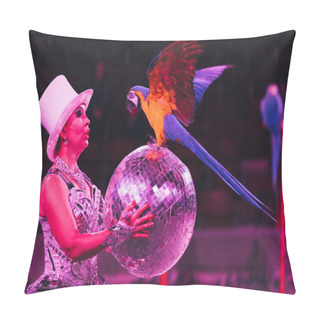 Personality  KYIV, UKRAINE - NOVEMBER 1, 2019: Side View Of Handler Holding Mirror Ball While Performing With Ara Parrot In Circus Pillow Covers