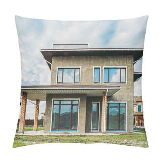 Personality  Facade Of Unfinished Modern Concrete Building With Green Yard Under Cloudy Sky Pillow Covers