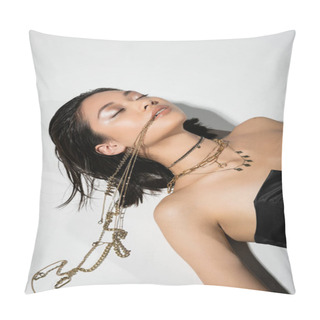Personality  High Angle View Of Young Asian Woman With Short Brunette Hair Holding Golden Jewelry In Mouth While Lying On Grey Background, Everyday Makeup, Wet Hairstyle, Closed Eyes  Pillow Covers