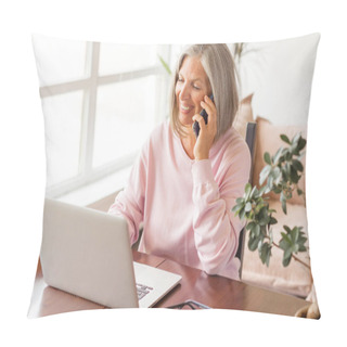 Personality  Smiling Casual Middle Aged Gray-haired Woman Using Laptop While Talking With Smartphone. Happy Mature Female Working With A Cellphone And Laptop At Home. Business Woman Using Her Mobile Phone  Pillow Covers
