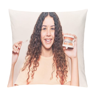 Personality  Adorable Latin Teenager Smiling Happy. Standing With Smile On Face Holding Denture With Bracket And Aligner Over Isolated White Background Pillow Covers