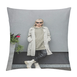 Personality  Full Length Of Young Woman In Stylish Sunglasses, Long Hoodie, Coat, Black Leather Pants And Beige Boots Standing Near Grey Wall Of Modern Building And Posing With Hands In Pockets Near Green Plant  Pillow Covers
