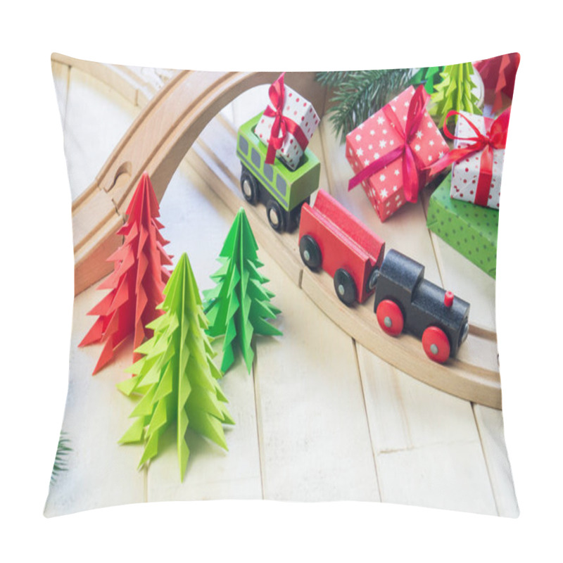 Personality  A toy wooden train carries a box with a gift to the child. Christmas magic city. Paper tree and star, decoration for the holiday. New Year's toy. pillow covers