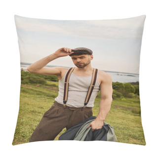 Personality  Trendy Bearded Man In Suspenders Touching Newsboy Cap And Holding Jacket While Looking At Camera With Rural Landscape At Background, Fashion-forward In Countryside Pillow Covers