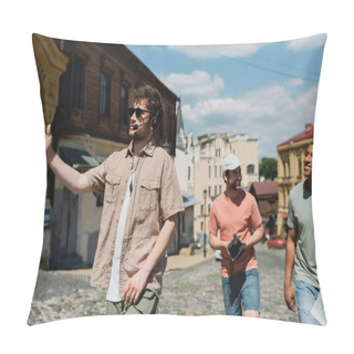 Personality  Young Guide In Headset And Sunglasses Pointing With Hand During Excursion With Interracial Men On Podil District In Kyiv Pillow Covers