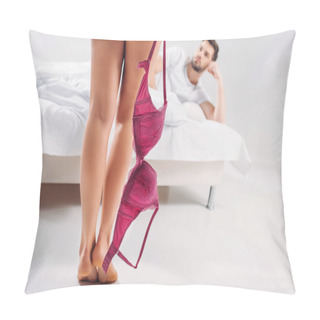 Personality  Selective Focus Of Woman With Bra In Hand And Boyfriend Lying On Bed Pillow Covers