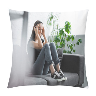 Personality  Selective Focus Of Young Woman Suffering From Depression While Sitting On Couch And Holding Hands Near Head Pillow Covers