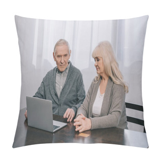 Personality  Upset Senior Couple Sitting At Table And Using Laptop At Home Pillow Covers