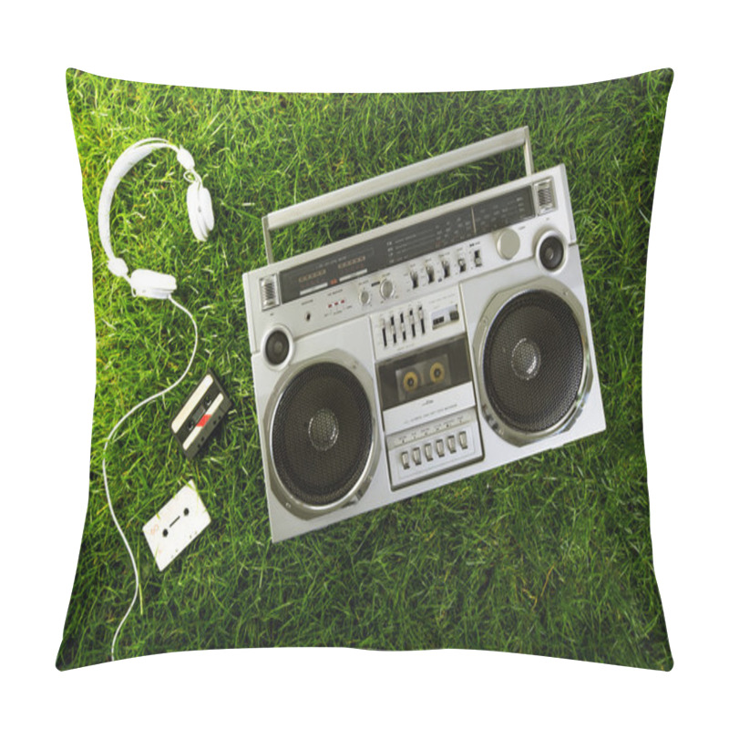 Personality  Retro-styled silver boom box, earphones and audio cassettes over pillow covers