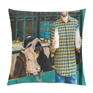 Personality  Cropped Image Of Smiling Farmer Holding Bottles Of Cow Milk Near Stable Pillow Covers