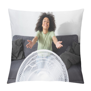 Personality  Joyful African American Woman Sitting With Outstretched Hands On Couch Near Blurred Electric Fan Pillow Covers