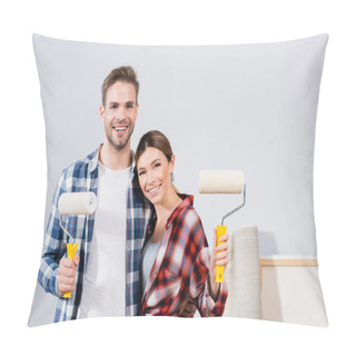 Personality  Front View Of Happy Young Couple With Paint Rollers Looking At Camera While Hugging At Home Pillow Covers