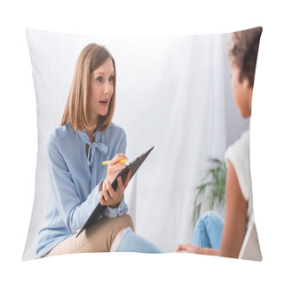 Personality  Surprised Psychologist Writing On Clipboard While Looking At African American Girl During Consultation On Blurred Foreground Pillow Covers