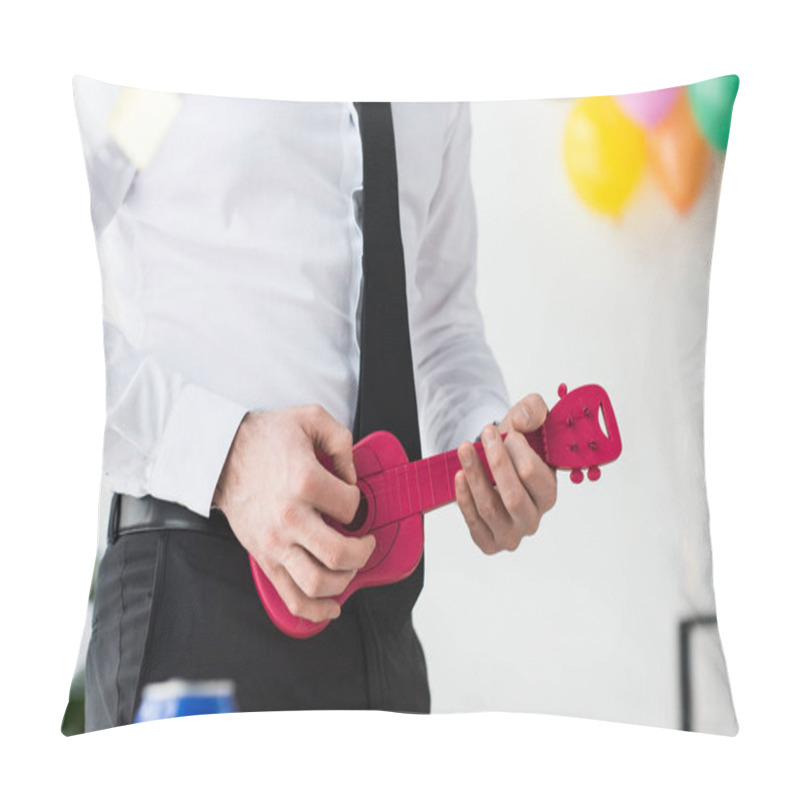 Personality  cropped shot of businessman pretending to play toy guitar in office pillow covers