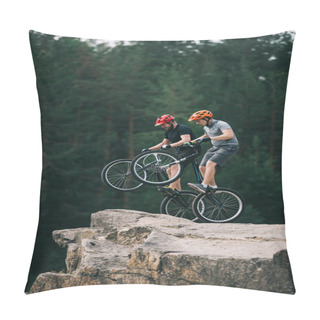 Personality  Risky Trial Bikers Standing On Back Wheels On Rocky Cliff With Blurred Pine Forest On Background Pillow Covers