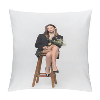 Personality  Sensual Woman In Lingerie, High-heeled Shoes And Black Blazer Sitting On High Stool With Branch Of Gypsophila On Grey Pillow Covers