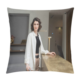 Personality  Confident Woman In Black Crop Top, White Shirt And Beige Pants, With Wavy Brunette Hair Standing Near Lamp On Reception Desk And Looking At Camera In Lobby Of Modern Hotel, Travel Lifestyle Pillow Covers