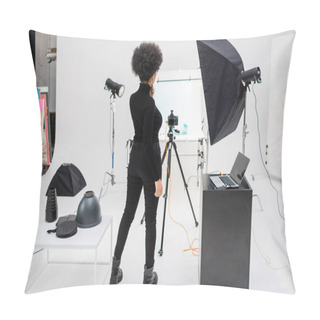 Personality  Back View Of African American Content Manager In Black Clothes Standing Near Laptop And Digital Camera On Tripod In Photo Studio Pillow Covers