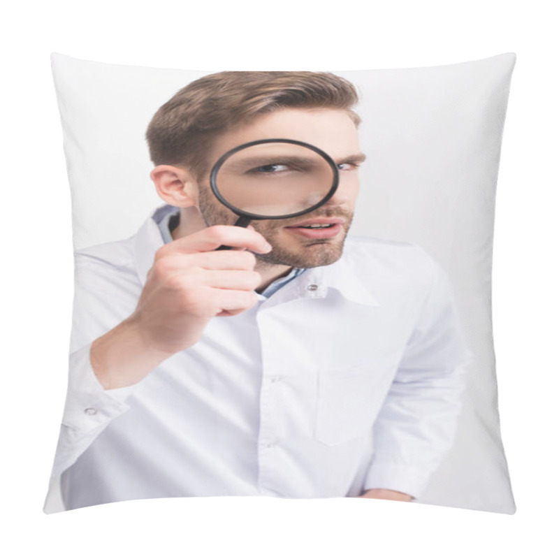 Personality  Curious ophthalmologist in white coat looking through magnifying glass isolated on white pillow covers