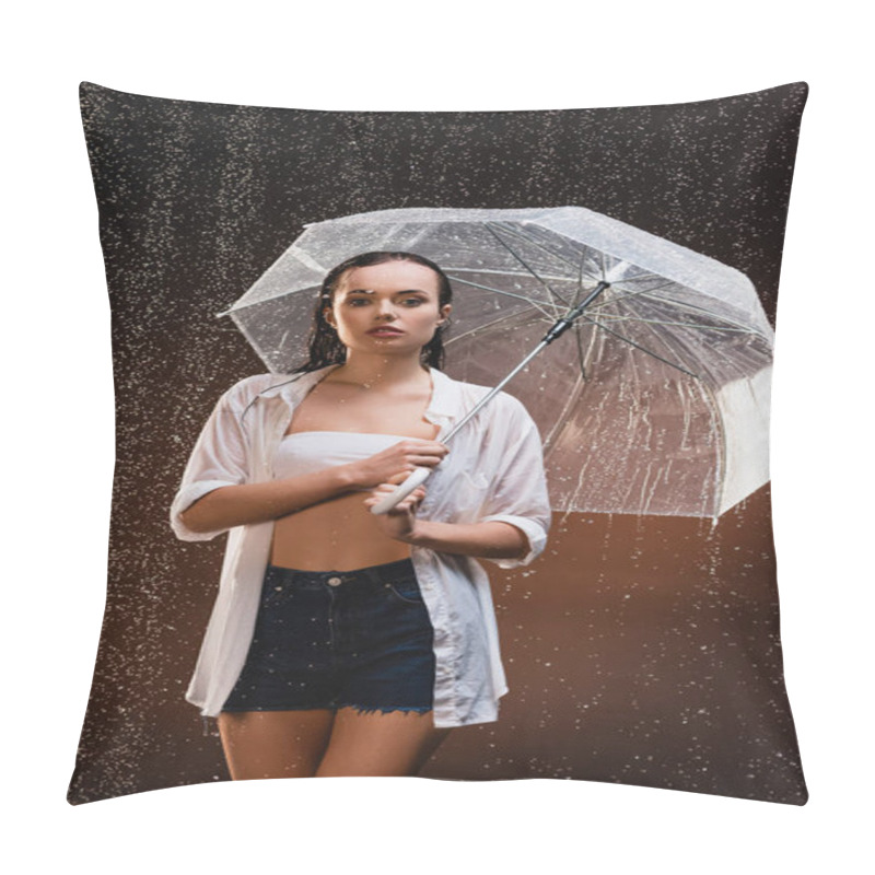 Personality  sensual, wet woman looking at camera while standing with umbrella under rain on dark background pillow covers