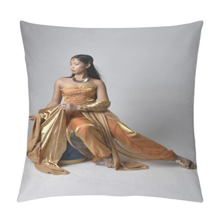 Personality  Full Length Portrait Of Pretty Young Asian Woman Wearing Golden Arabian Robes Like A Genie, Seated Pose, Isolated On Studio Background. Pillow Covers