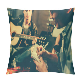 Personality  Selective Focus Of Cheerful Composer Writing In Notebook Near Friend Playing Acoustic Guitar  Pillow Covers