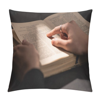 Personality  KYIV, UKRAINE - JANUARY 17, 2020: Cropped View Of Woman Reading Holy Bible In Dark With Sunlight Pillow Covers