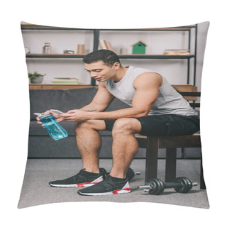 Personality  Mixed Race Man Holding Sport Bottle And Using Smartphone While Sitting On Chair In Living Room  Pillow Covers