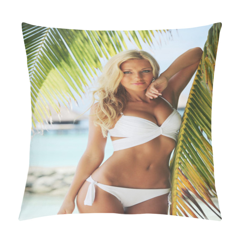 Personality  Woman in bikini under palm pillow covers
