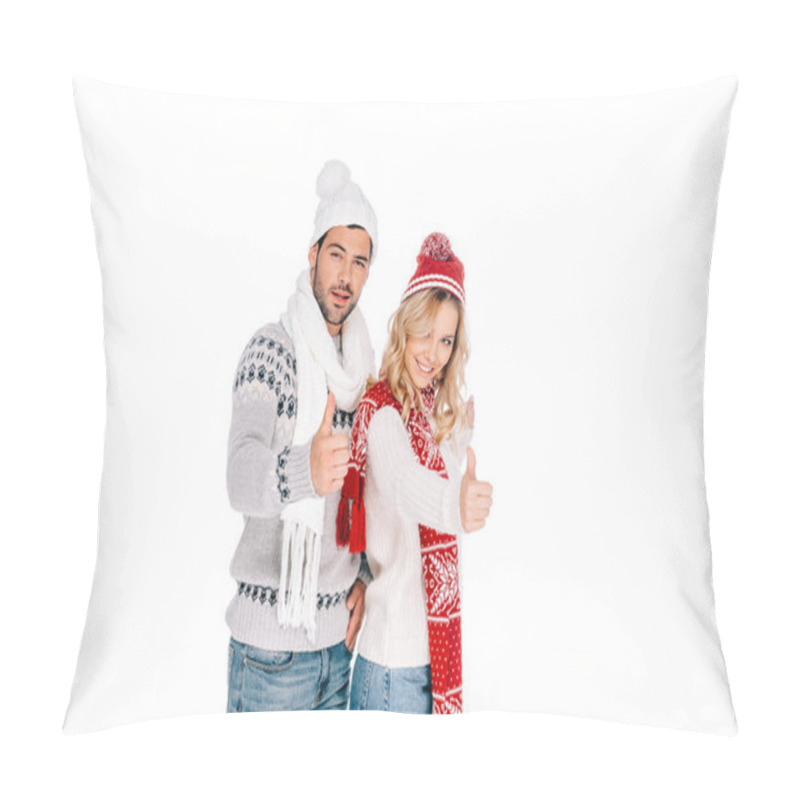 Personality  beautiful young couple in winter outfit showing thumbs up and smiling at camera isolated on white pillow covers