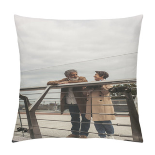 Personality  Cheerful Senior Man In Coat Looking At Pleased Wife While Leaning On Guard Rail Of Bridge  Pillow Covers
