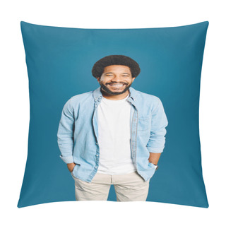 Personality  A Brazilian Young Man With A Friendly Smile And A Casual Denim Outfit Stands With A Relaxed Posture, Hands In Pockets, Exuding Warmth And Approachability Against A Monochrome Blue Backdrop Pillow Covers