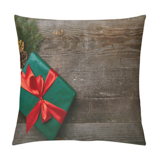 Personality  Top View Of Wrapped Green Present With Red Ribbon And Christmas Toys On Wooden Background Pillow Covers