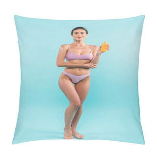 Personality  Smiling Woman In Swimsuit Standing With Orange Sunblock Bottle On Blue  Pillow Covers