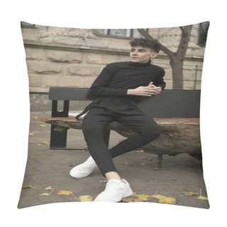 Personality  Cheerful Young Man With Modern Hairstyle Dressed In Black, Sitting On A Bench, Relaxed, Looking Sideways. Pillow Covers