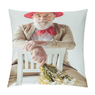 Personality  Selective Focus Of Stylish Senior Man In Red Hat Holding Wildflowers And Looking At Camera On Chair Isolated On White Pillow Covers