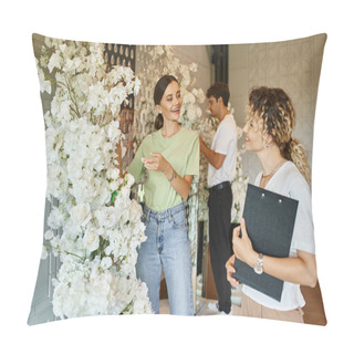 Personality  Young Smiling Florist Showing White Floral Decor To Event Manager With Clipboard In Event Hall Pillow Covers