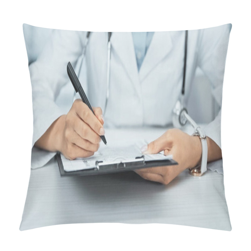 Personality  cropped view of african american doctor writing on clipboard in clinic  pillow covers