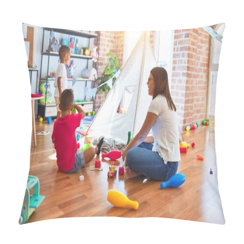 Personality  Young beautiful teacher and toddlers playing around lots of toys at kindergarten pillow covers