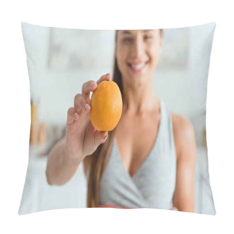 Personality  selective focus of happy young woman holding tasty orange  pillow covers