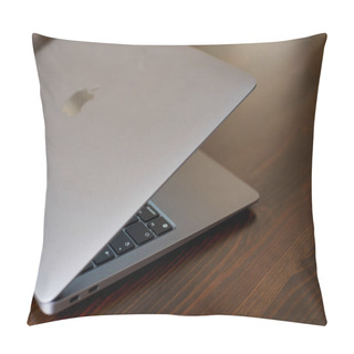 Personality  UK, Newcastle Upon Tyne, 20 July 2022 - MacBook Air 2020-2022. An Ajar MacBook Air Stands On A Wooden Table. The Image Of The Apple Logo On The Lid And A View Of The Glowing Keyboard. Side View. Pillow Covers